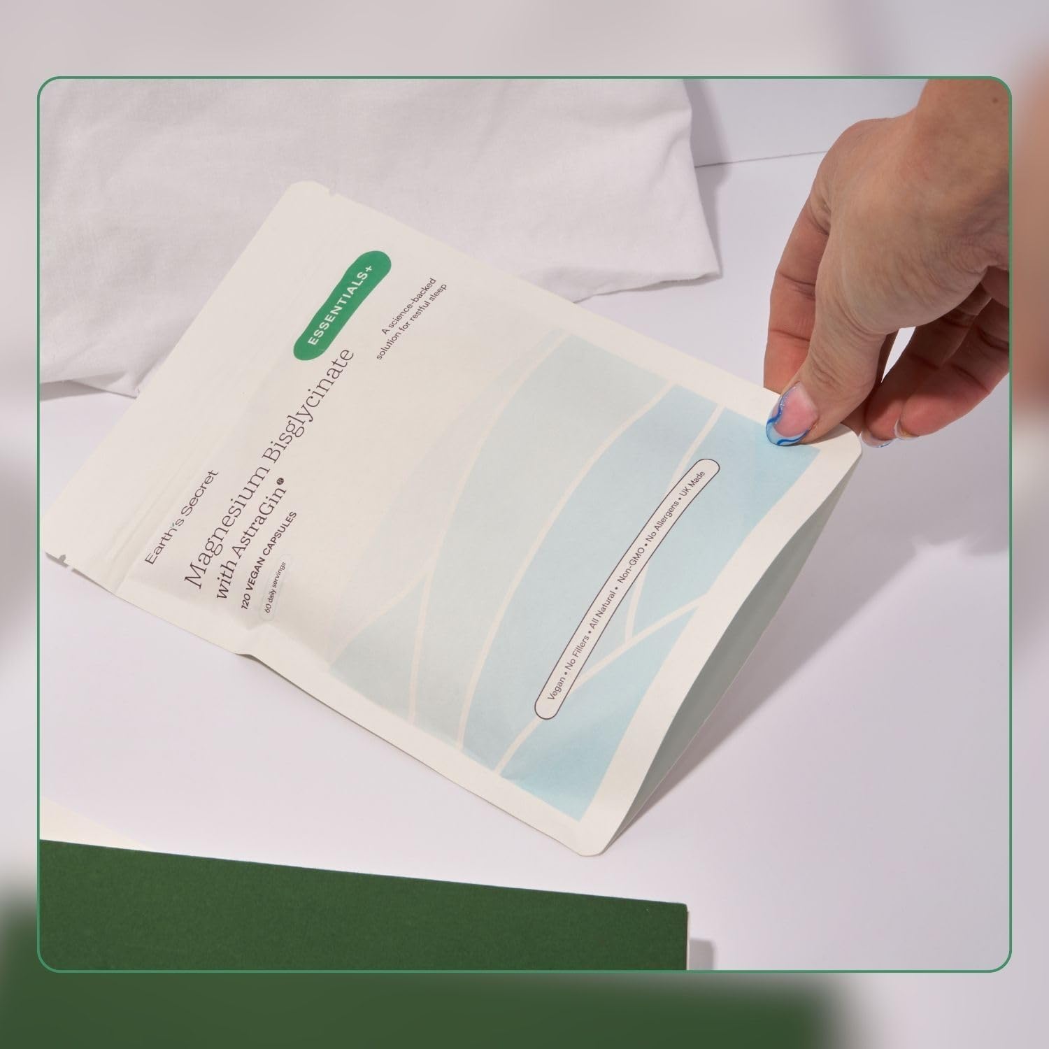 Hand holding a skincare sheet mask with a white background