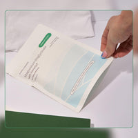 Hand holding a skincare sheet mask with a white background