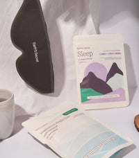 Sleep mask and eye pillow with branded packaging on a light surface