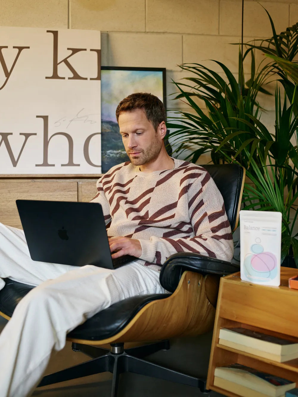 Working at a laptop with Earth&rsquo;s Secret Balance on the side table